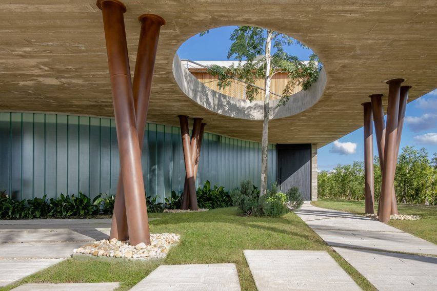 Anada House has a curved walkway supported by columns