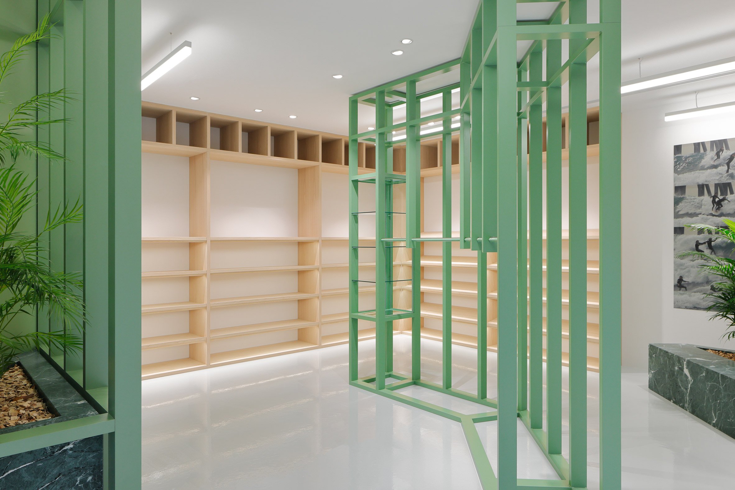 Green and wooden shelving in retail interior by Perron-Roettinger