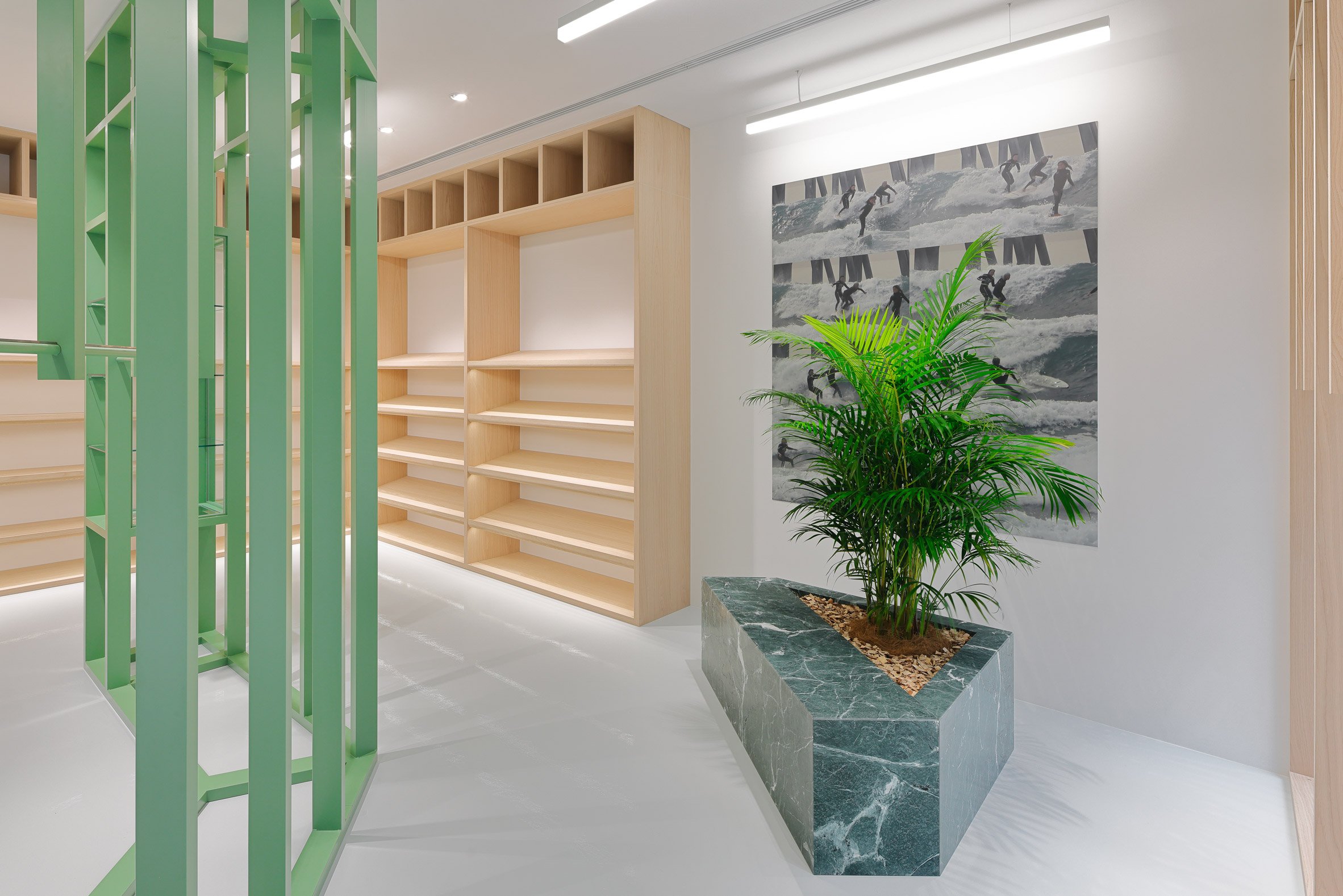 Green and wood shelving with green marble planter in Stüssy Shibuya store