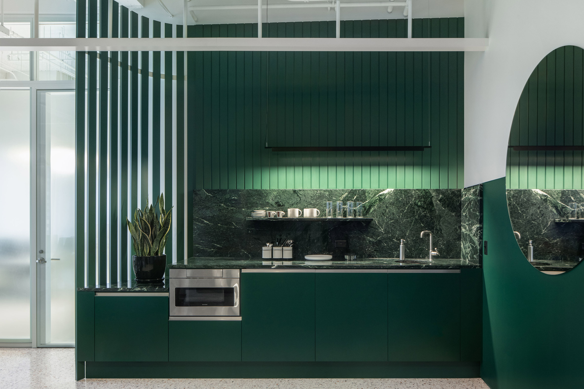 Green kitchen of office interior in Chicago by HHF and Kwong Von Glinow 
