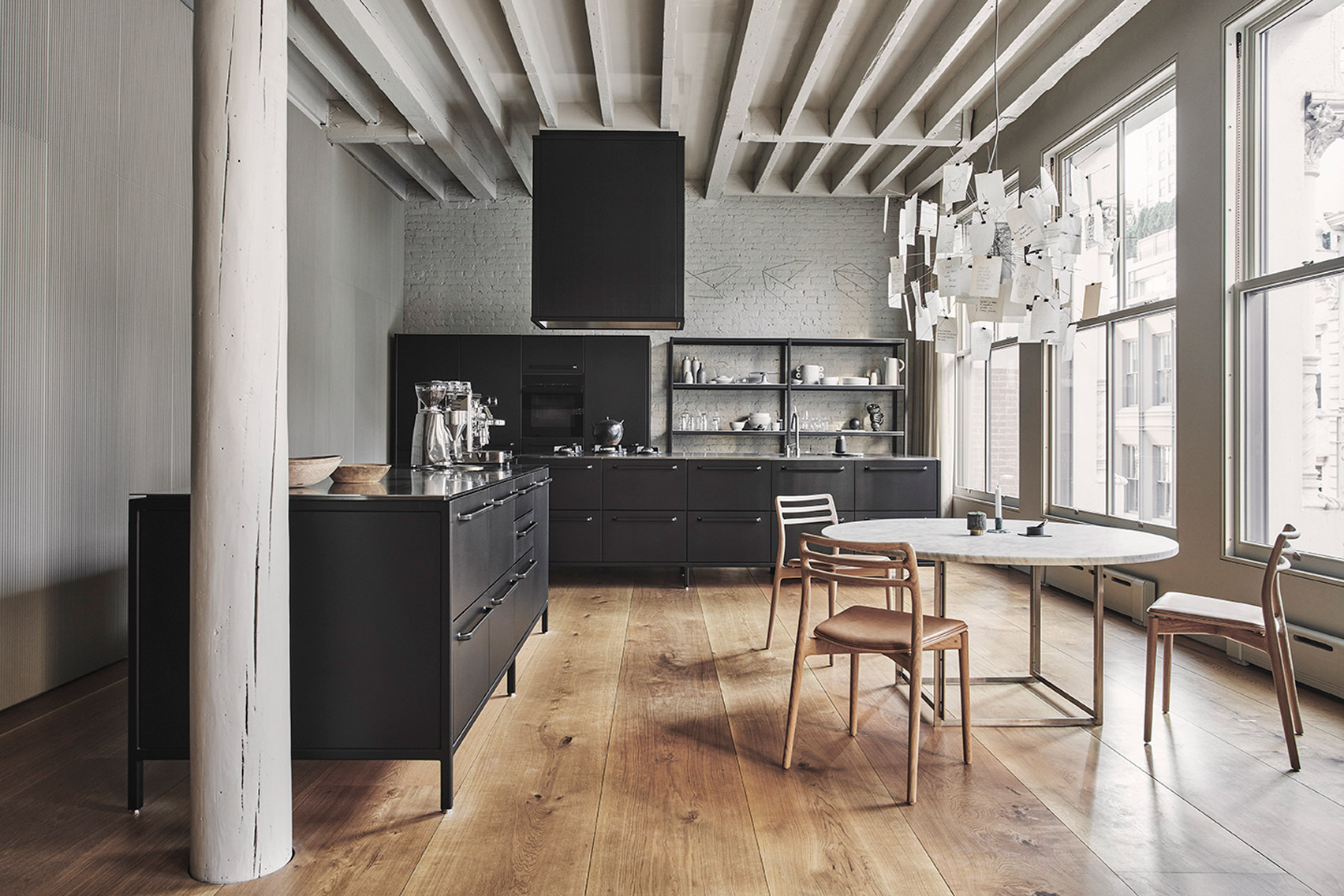 A grey toned kitchen and dining area in an apartment