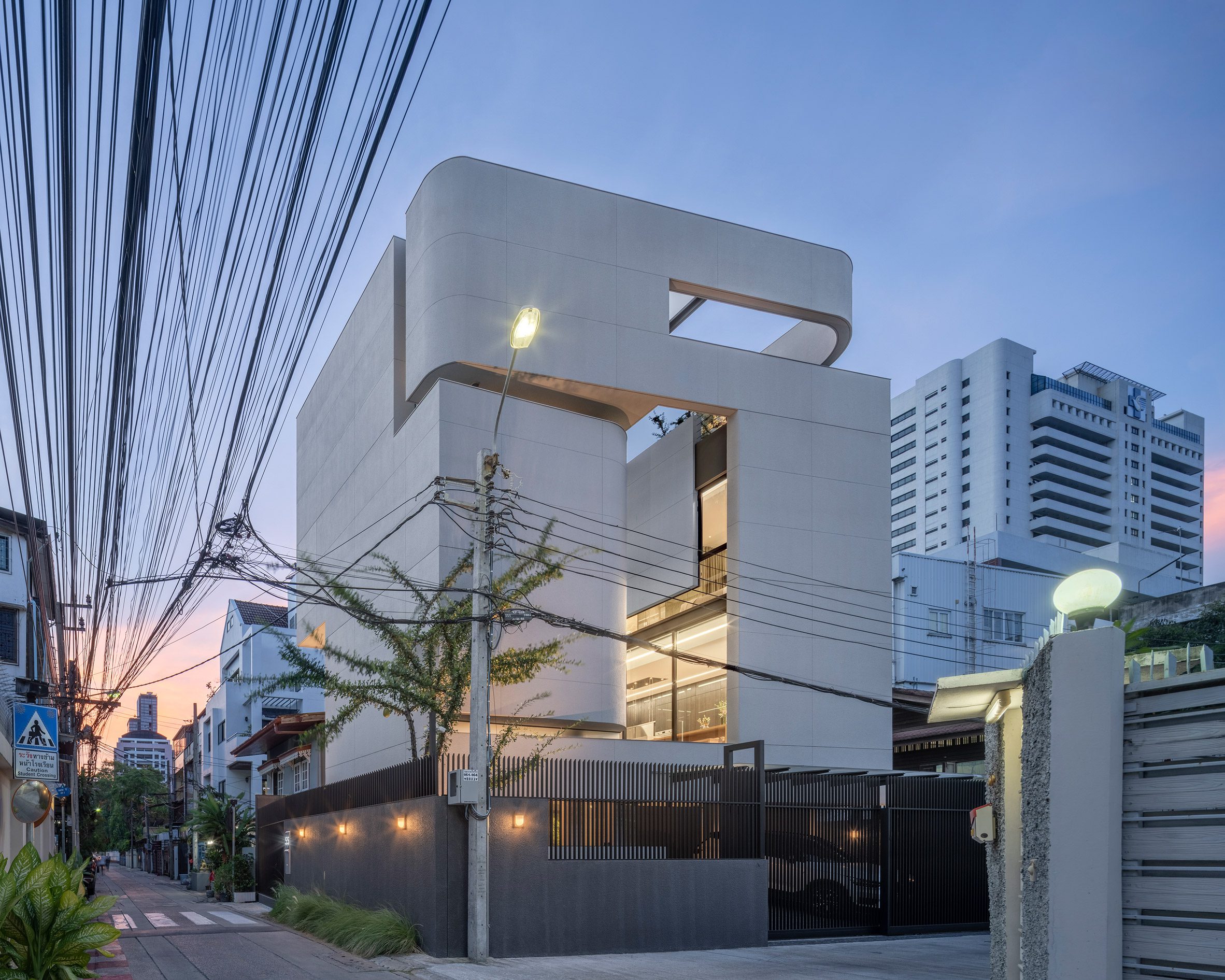 Sunset view of the exterior of 55 Sathorn house by Kuanchanok Pakavaleetorn Architects