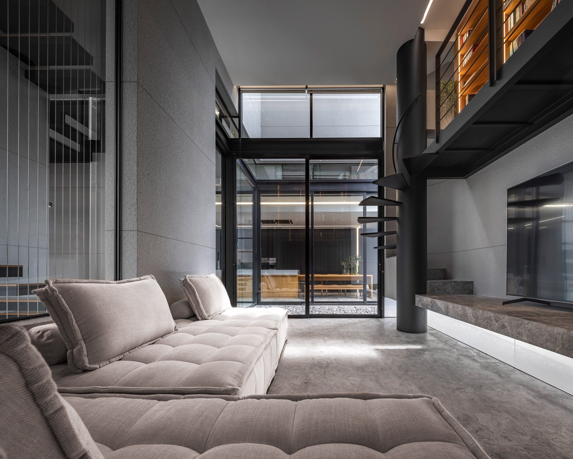Living room with mezzanine study, 55 Sathorn house by Kuanchanok Pakavaleetorn Architects