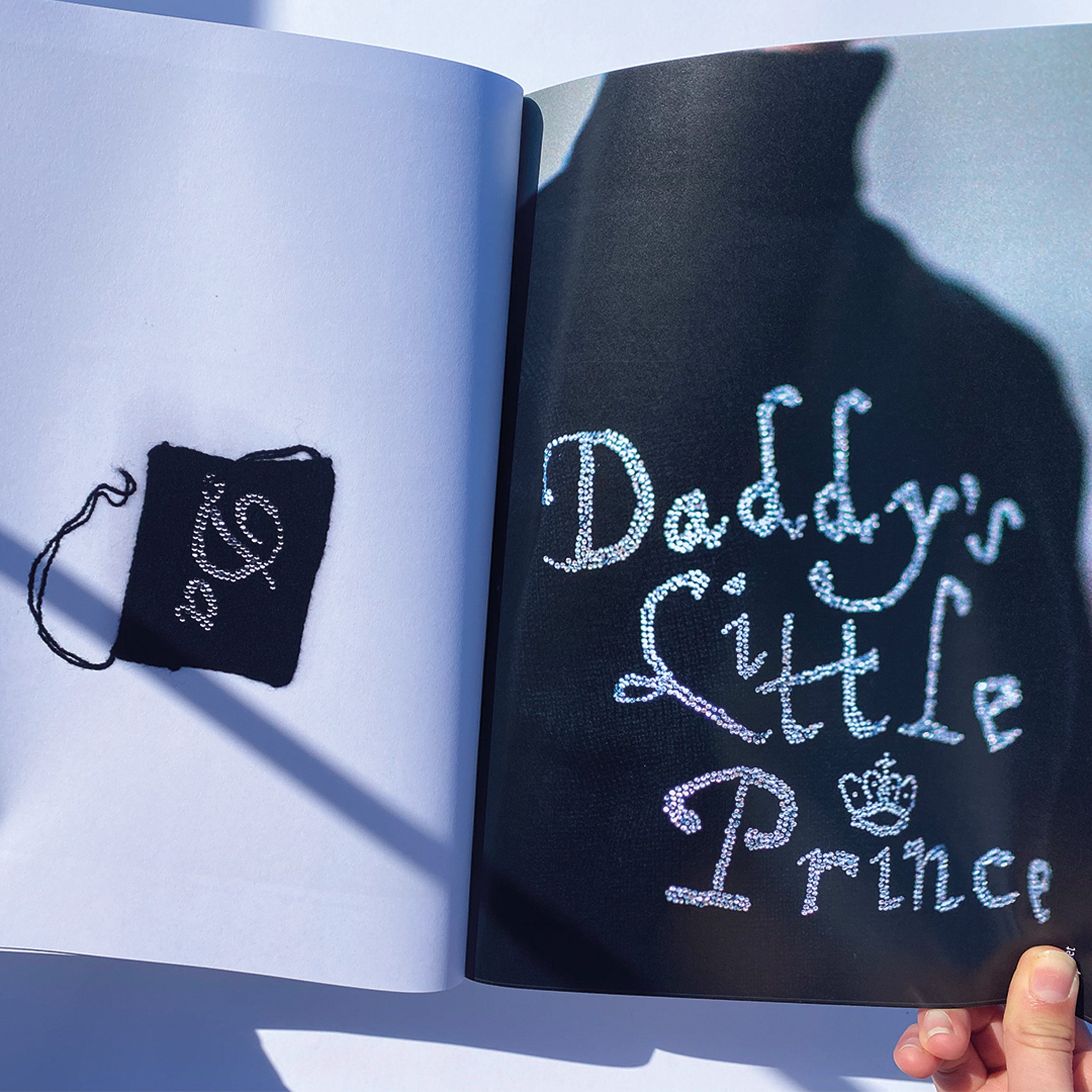 A book of embroidered work. This page says "Daddy's little Prince"