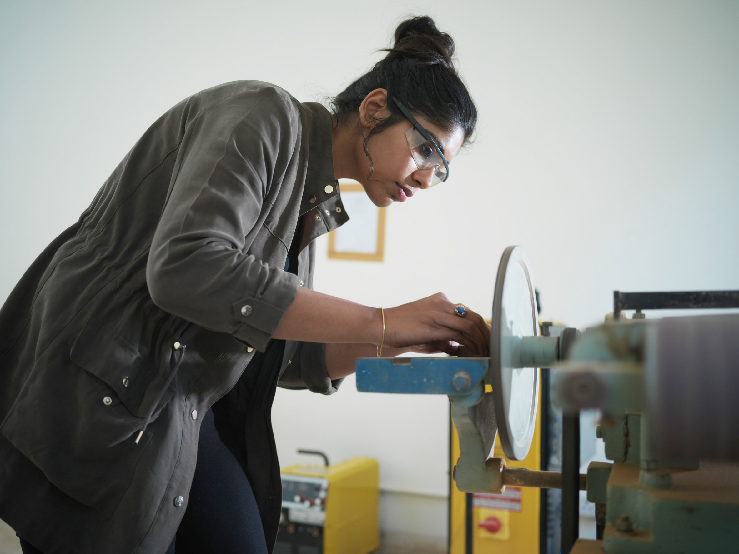 A Pearl Academy design student operating a machine