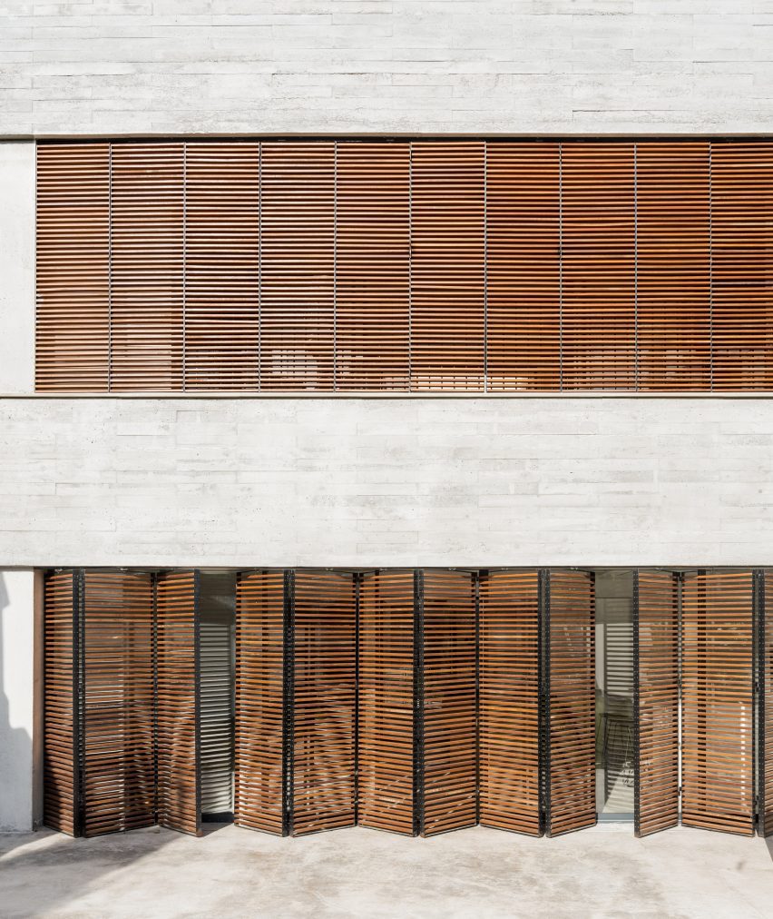 Large rectangular windows punctuate the concrete facade 