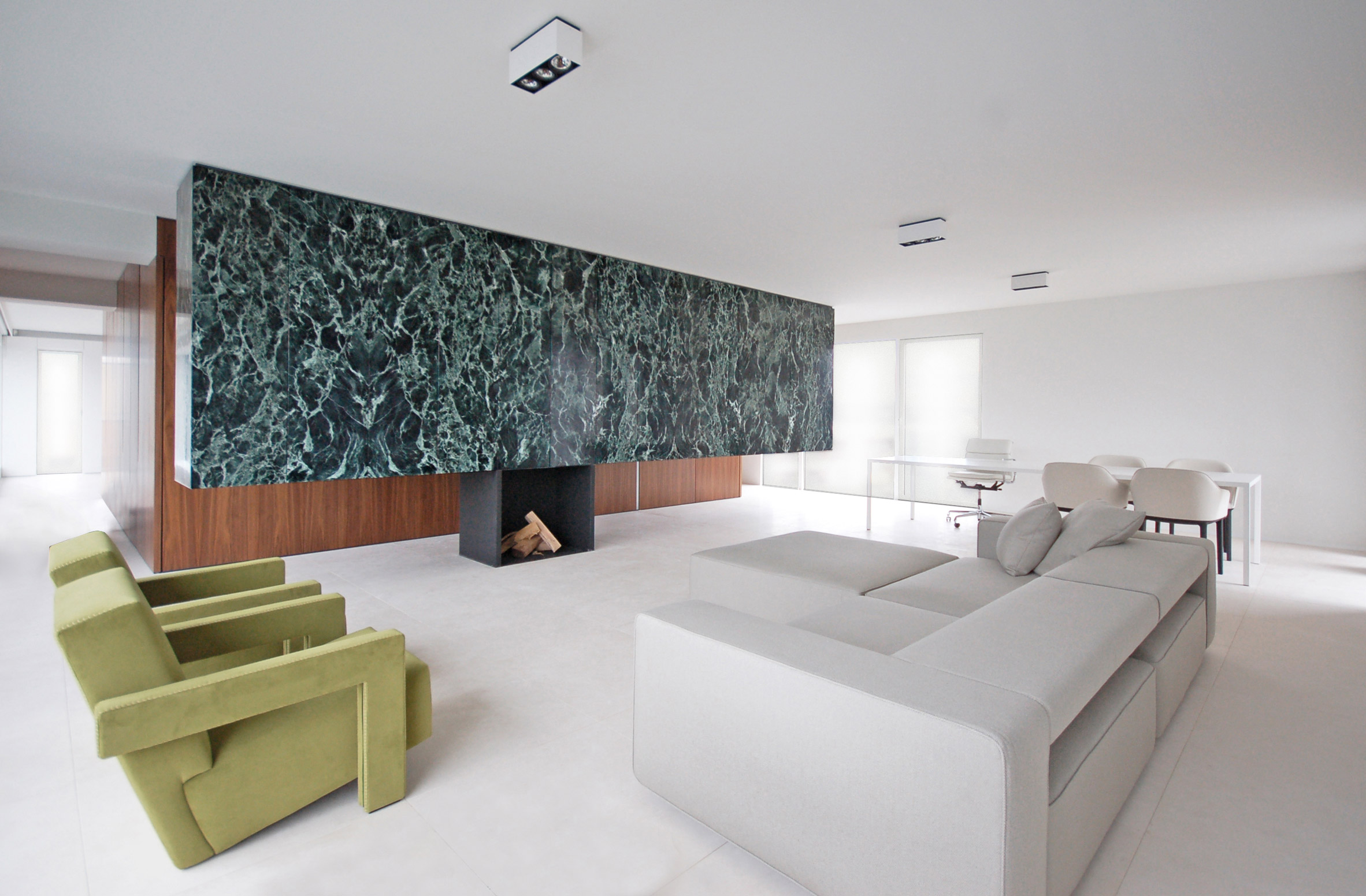 A white living room with a marble partition