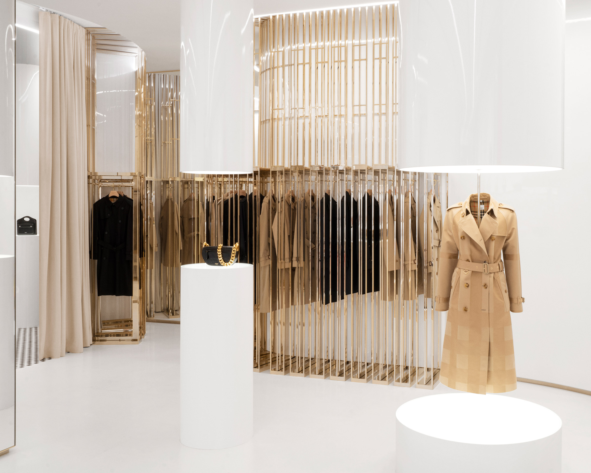 Burberry trench coat displayed in London flagship using champagne-coloured steel rails
