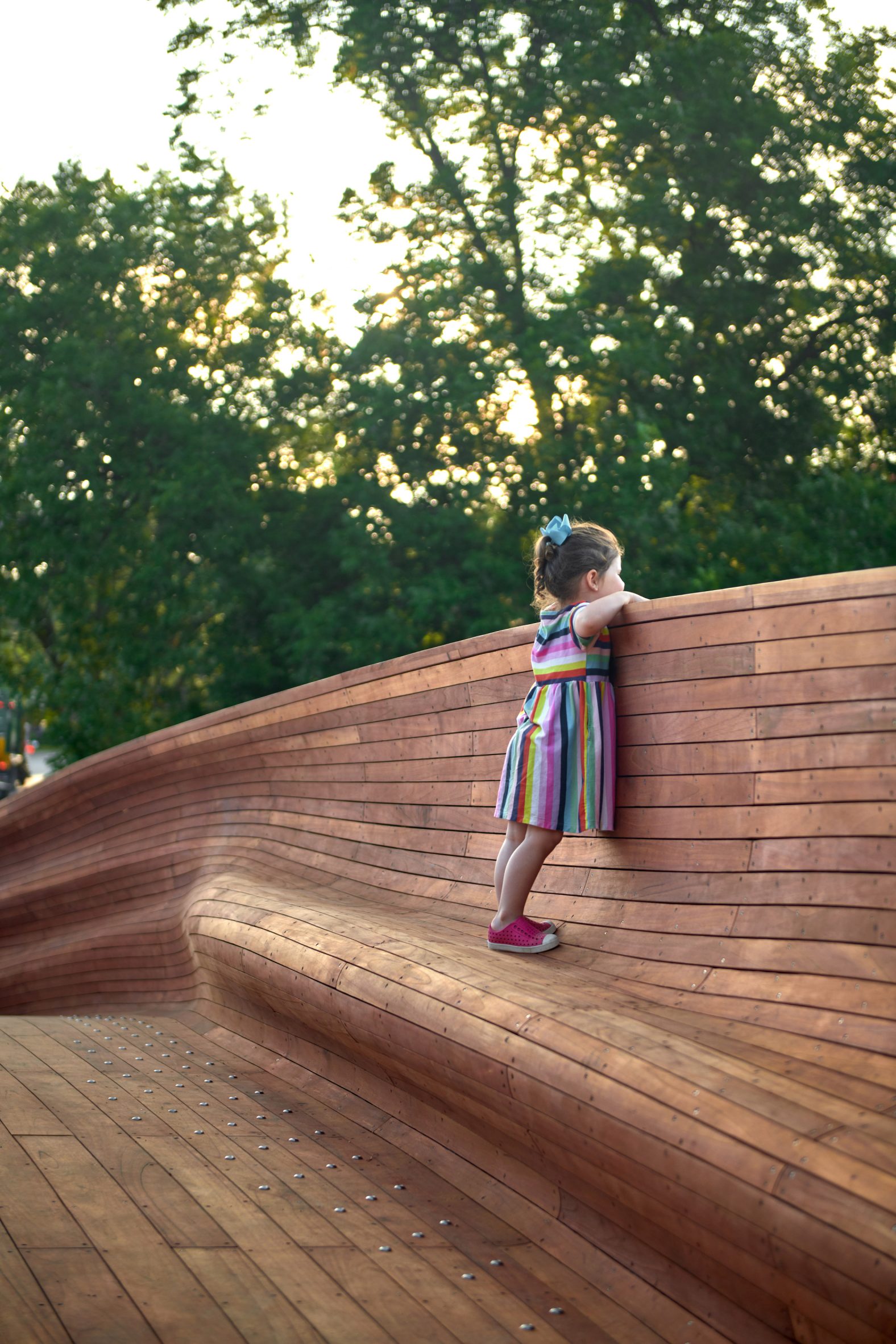 Girl standing on wooden bridge