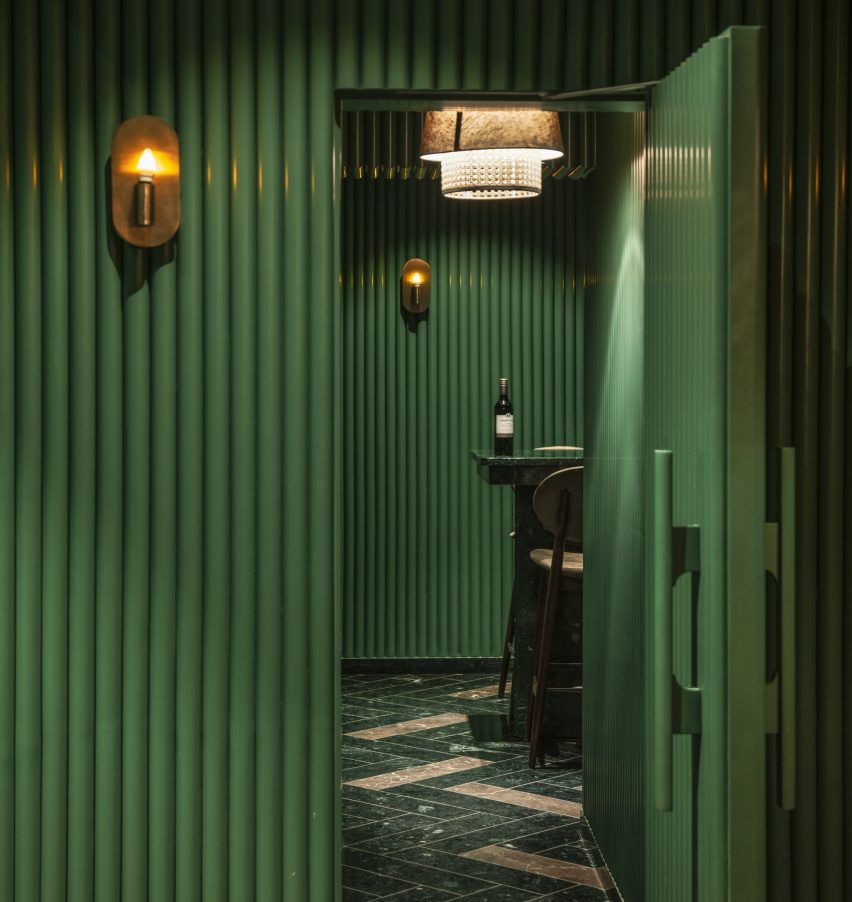 A green door opens into a bar
