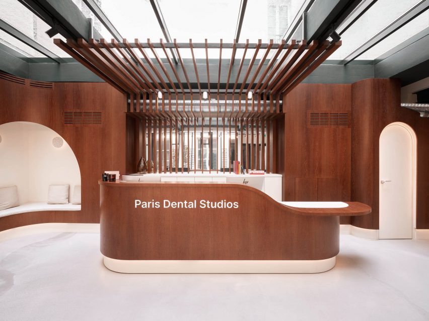 A brown wooden reception desk in Paris Dental Studios