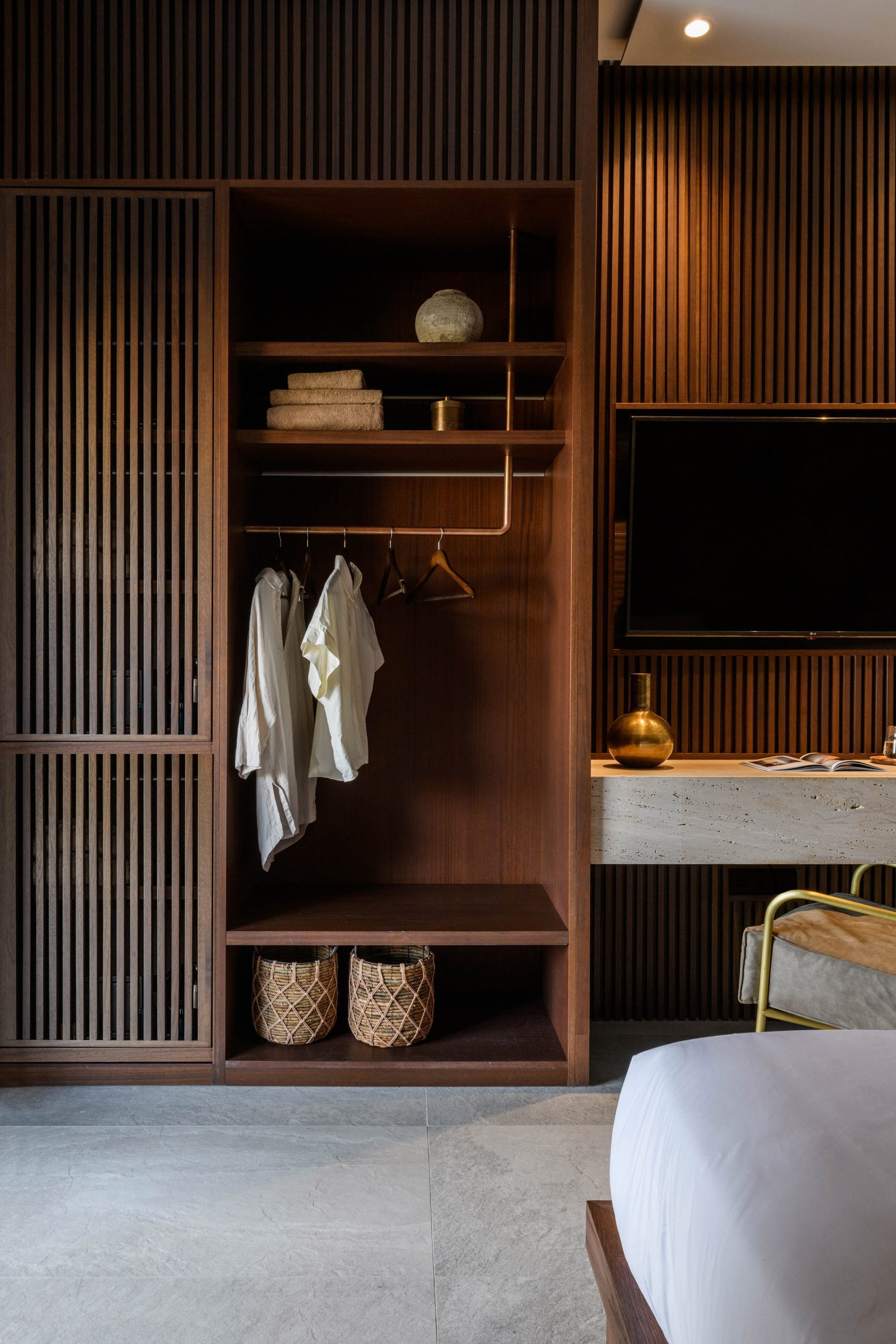 Wood-panelled bedroom with built-in wardrobe in Mykonos Wellness Resort