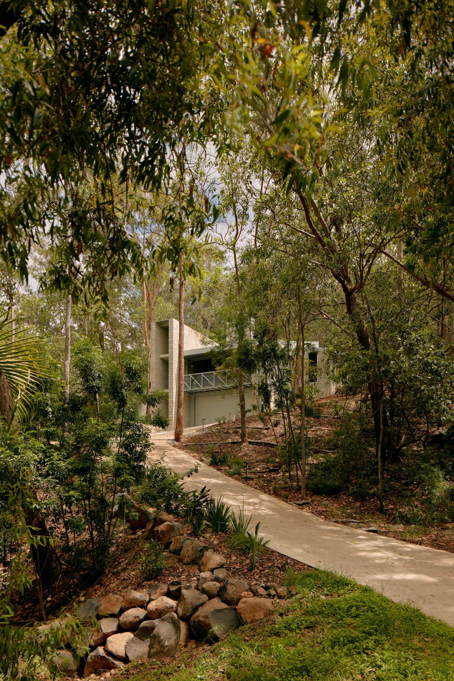 Driveway leading up to Mt Coot-Tha House with triple-height concrete staircase block