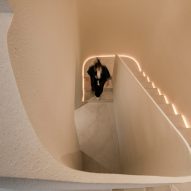 A woman walking up a set of white stairs