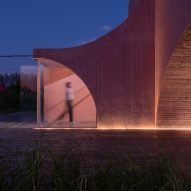 A curved concrete community pavilion