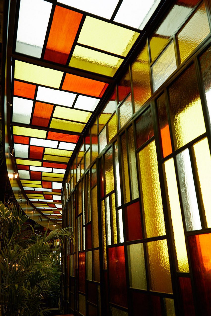 Wall of stained glass windows in restaurant interior by Pirajean Lees