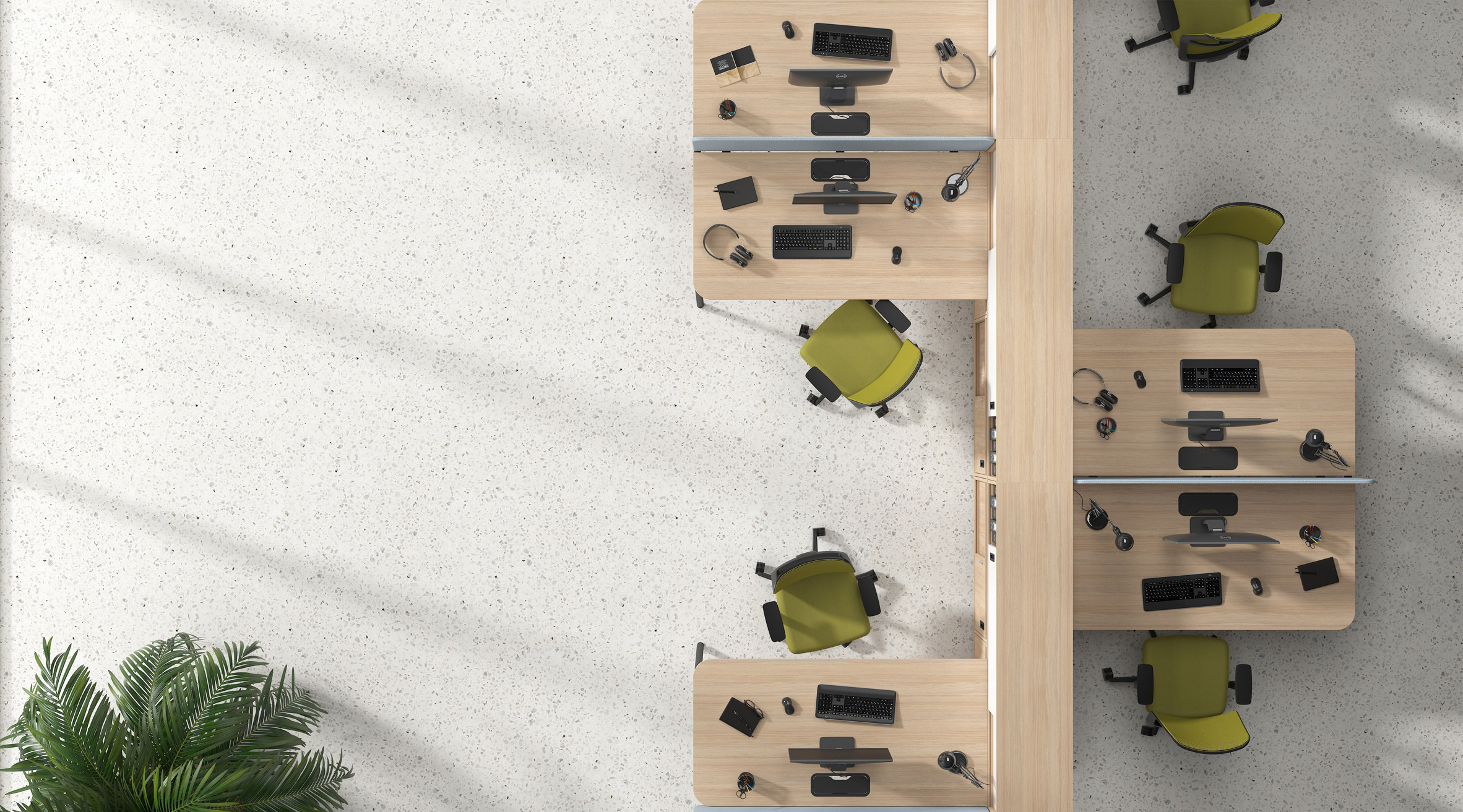 Pale wood desks configured into workstations around a dividing cabinet