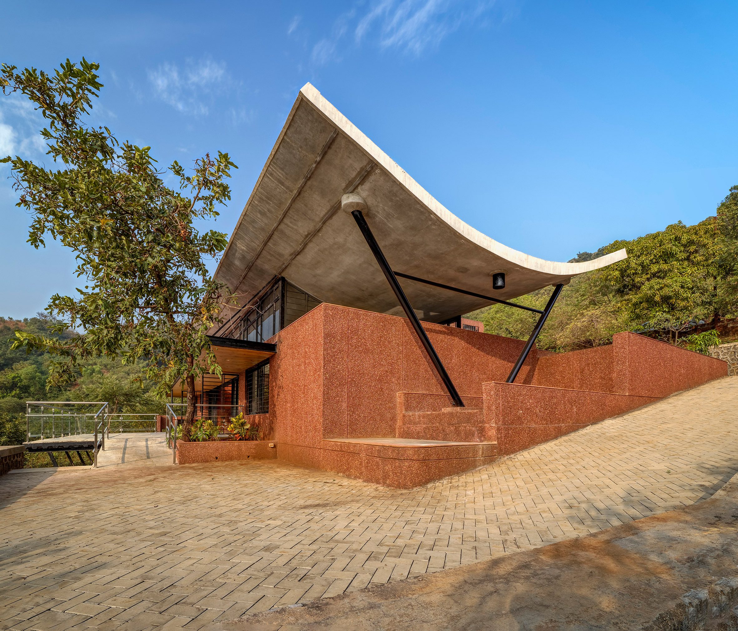 Red brick exteriof of The Cove House in the Western Ghats mountains