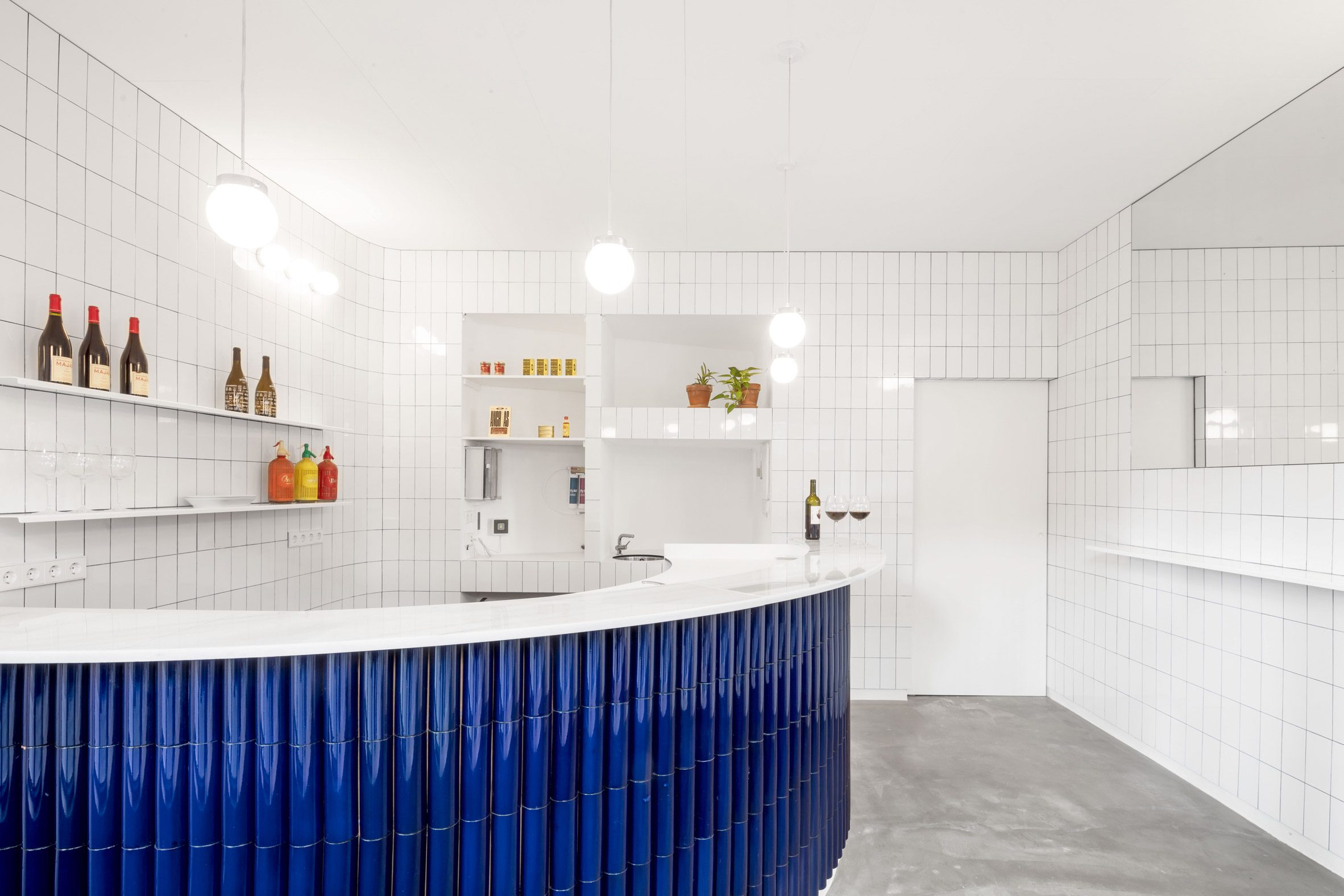 A bar featuring white and blue tiles from the Tiles of Spain Awards