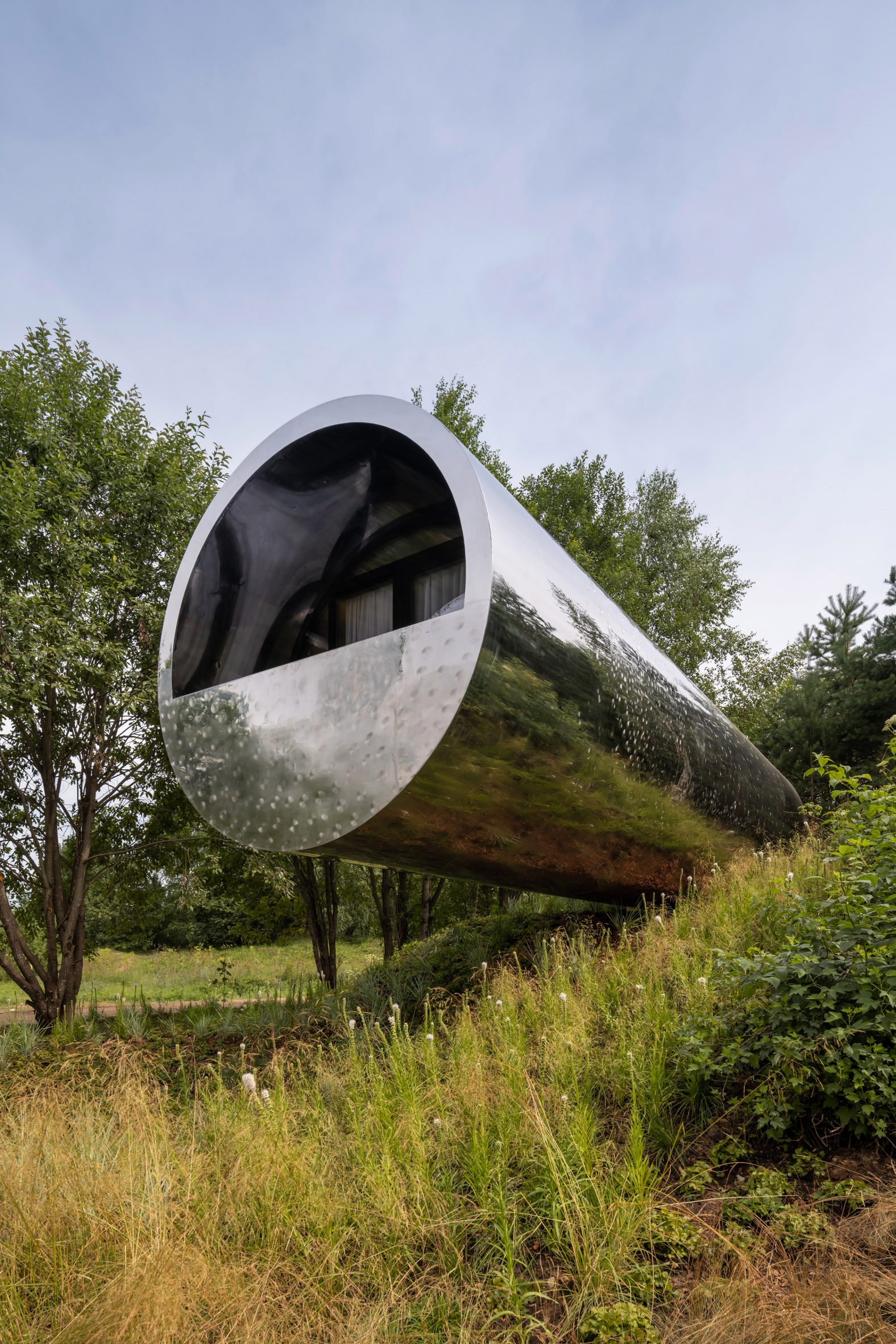Tube-shaped house with stainless steel cladding by Sergey Kuznetsov