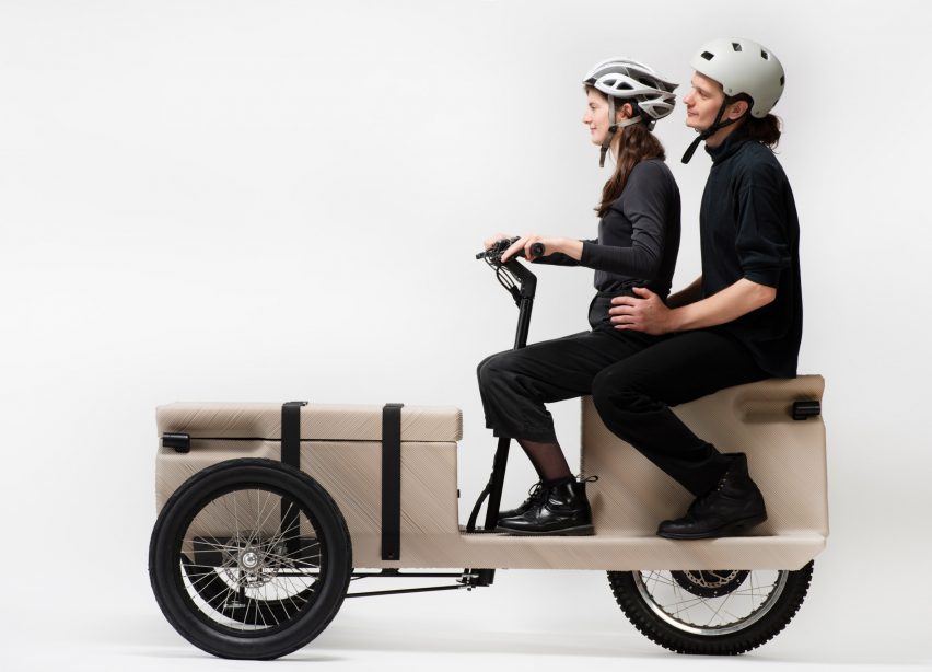 Two people sitting on a 3d printed bicycle by EOOS NEXT