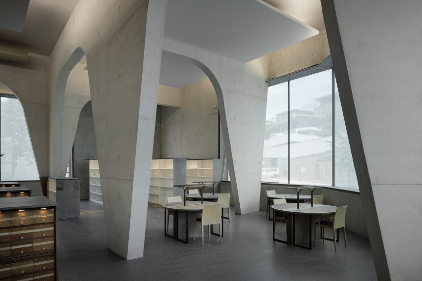 Work spaces at Contemporary International Resource Library are pictured between large concrete columns