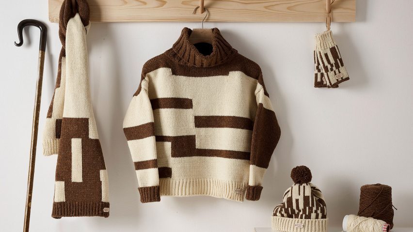 Brown and cream knitwear hanging against a white background
