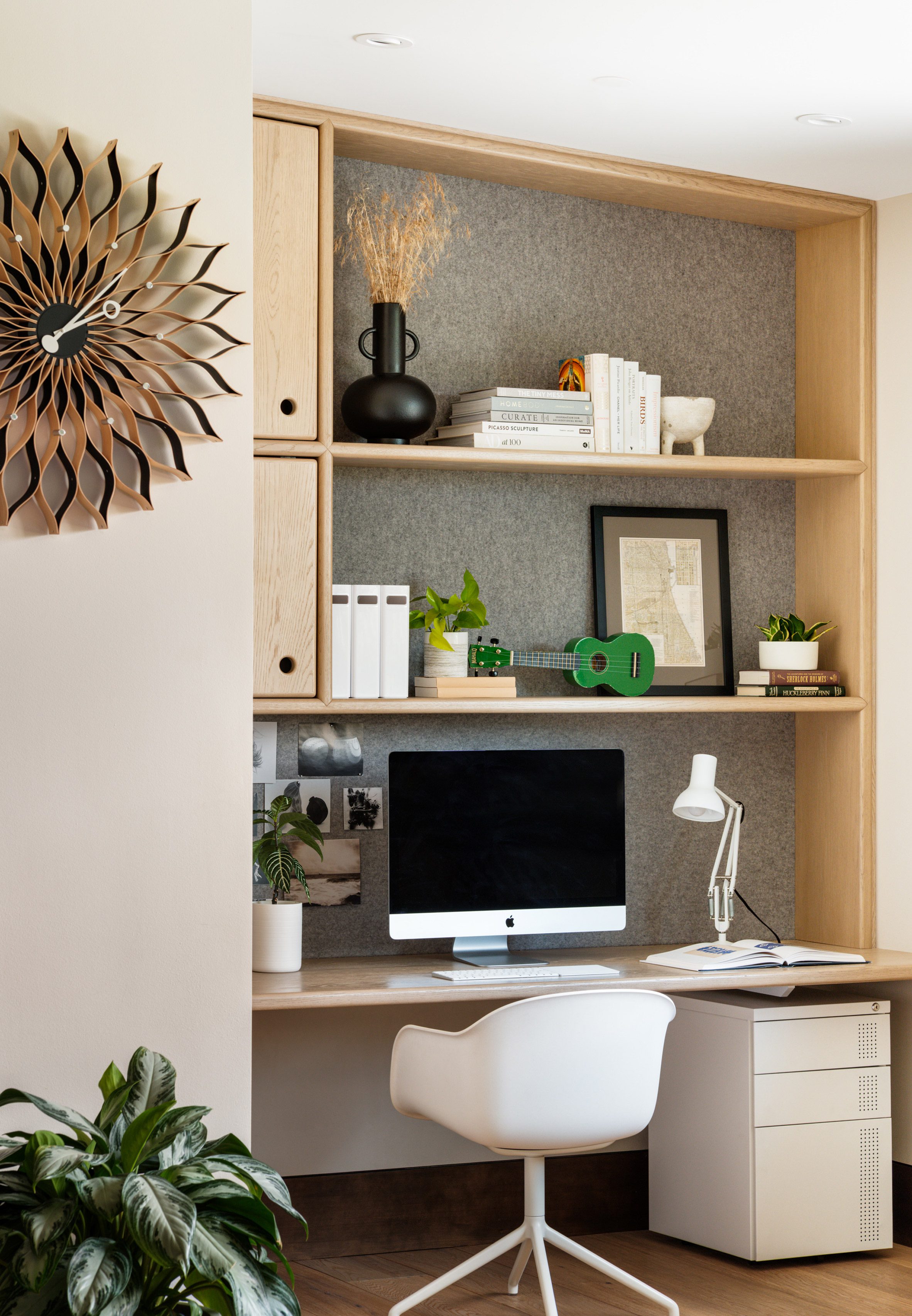Desk and bookshelf in Living room in Flatirons Residence by Tumu Studio