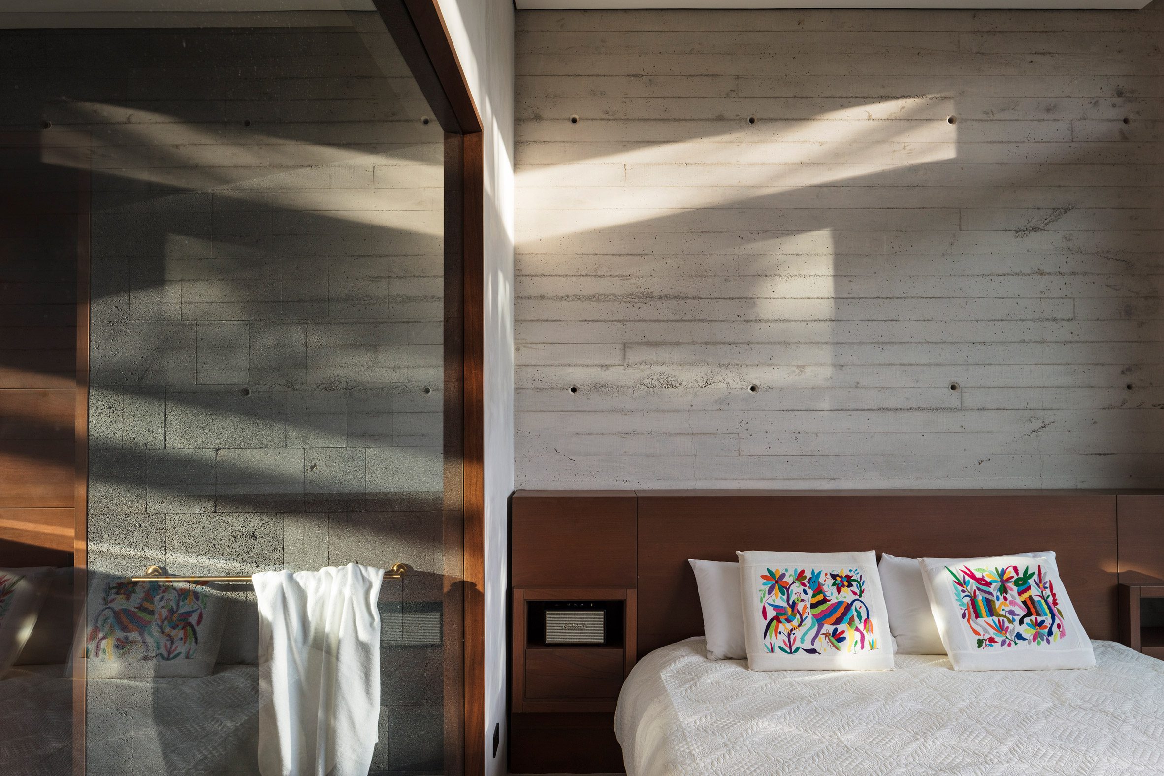 A guest bedroom with concrete walls