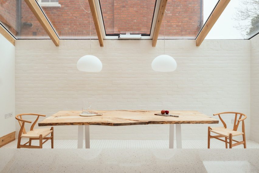 A dining room with a whitewashed brick