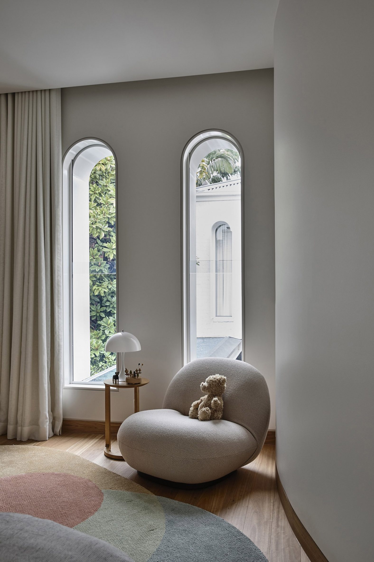 Tall and slender arched windows look out to the garden at Fitzroy Bridge House