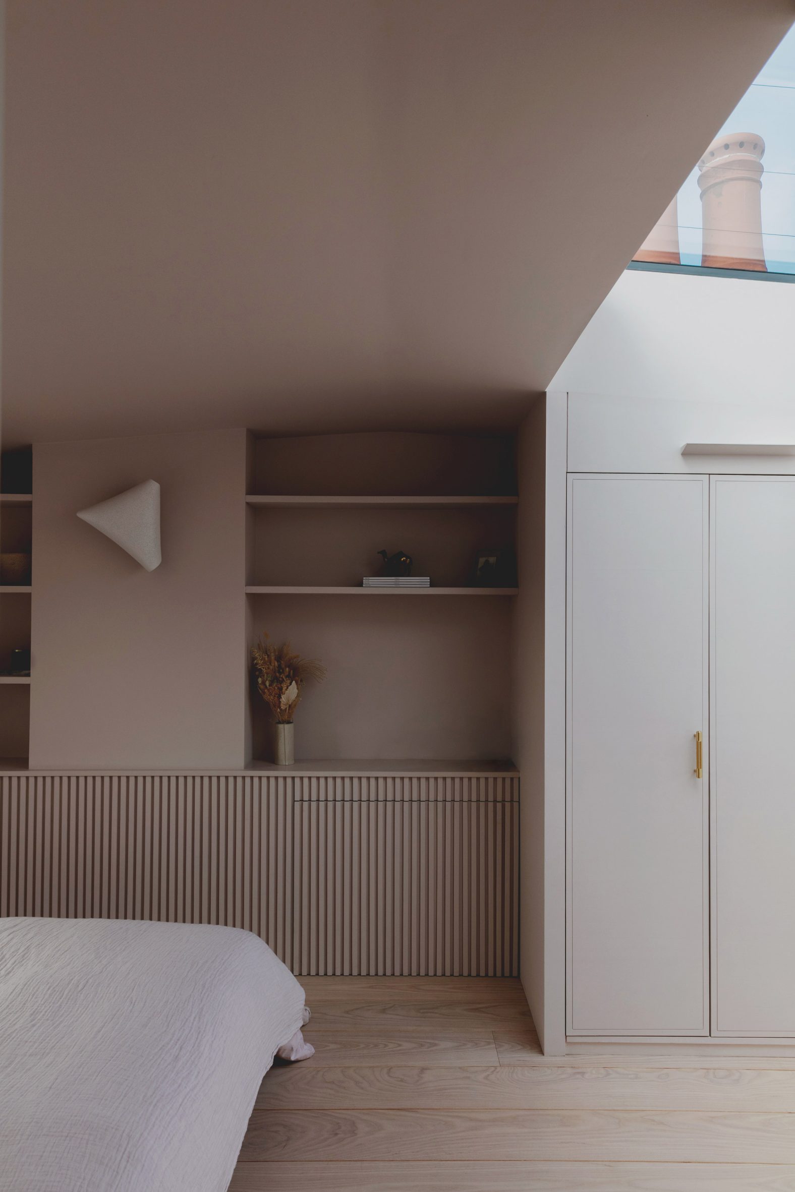 Shelves and closets in Bed and window in Narford Road loft extension by Emil Eve Architects