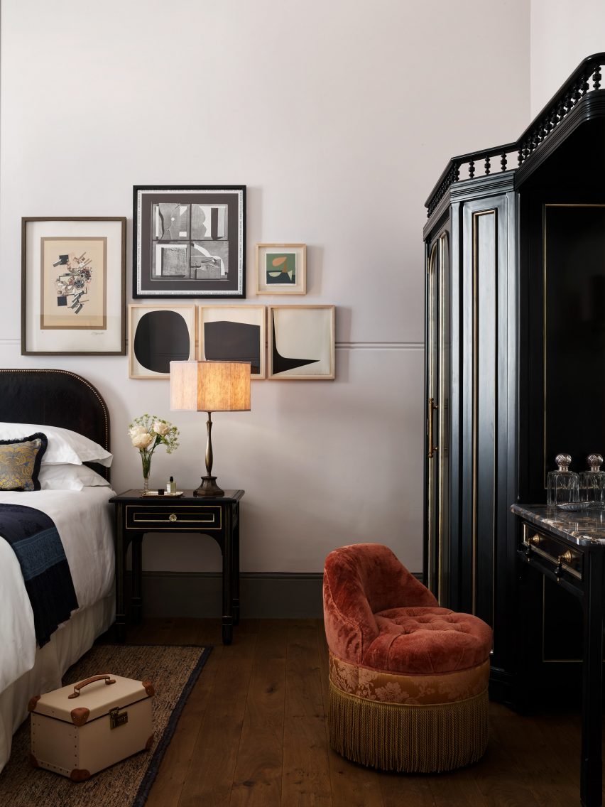 Guest room in NoMad London with tasseled velvet poof