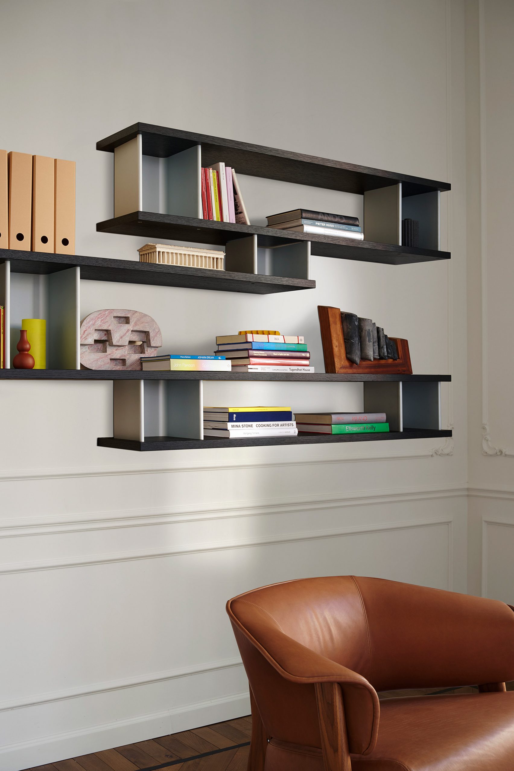A photograph of the wall-mounted shelf system 