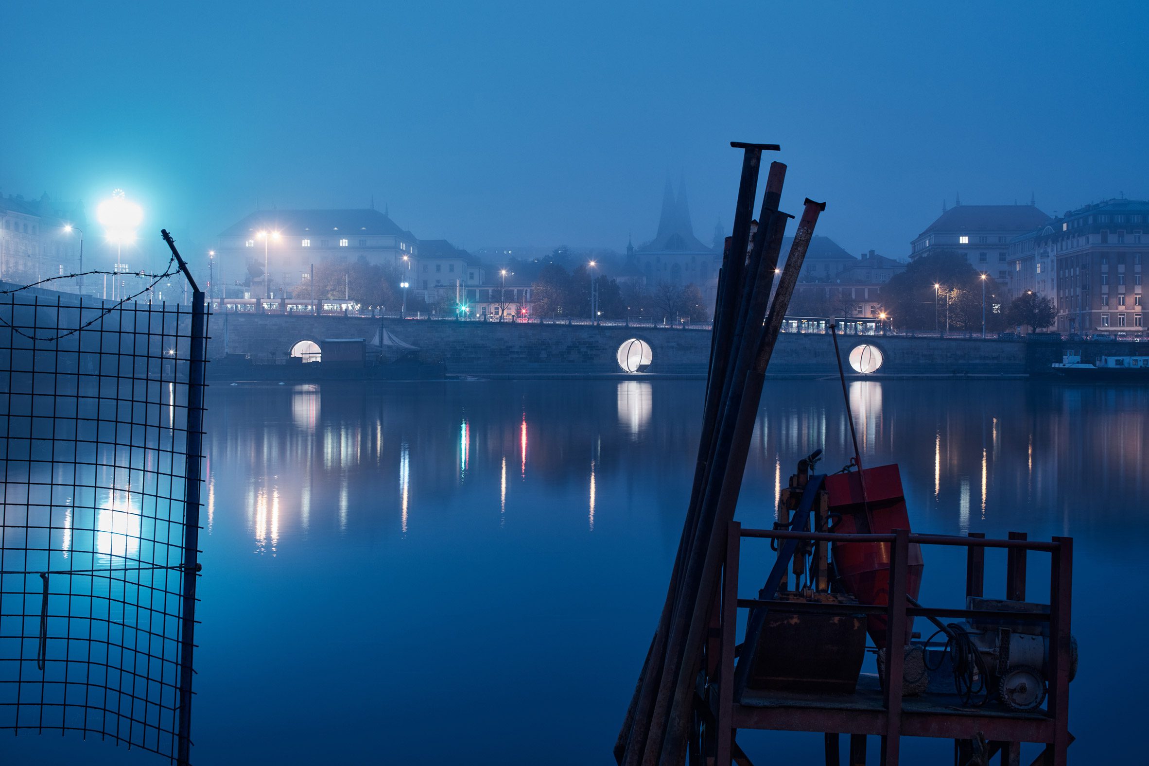 The Prague waterfront is illuminated by the public space