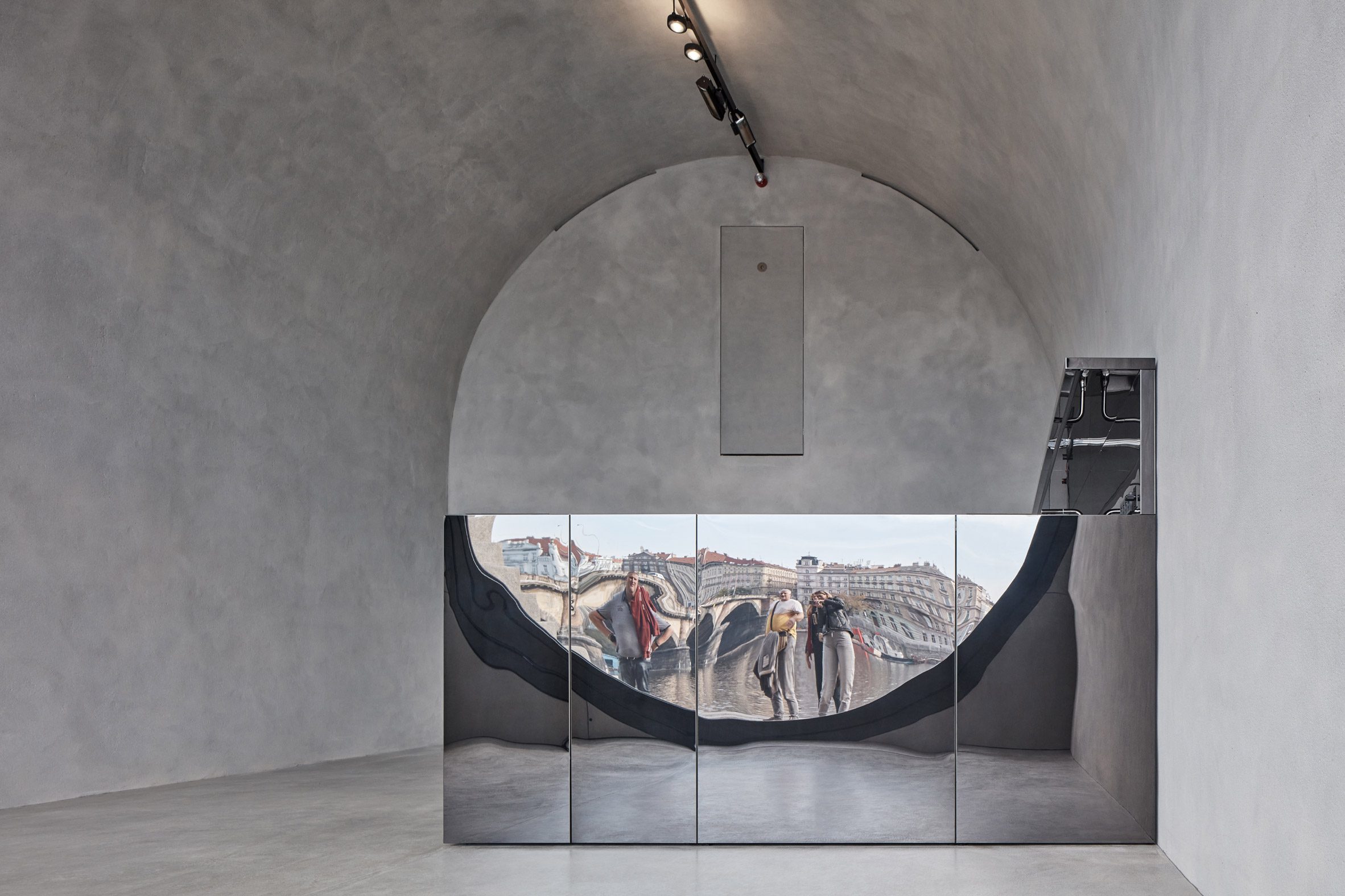A mirrored counter reflects the prague waterfront