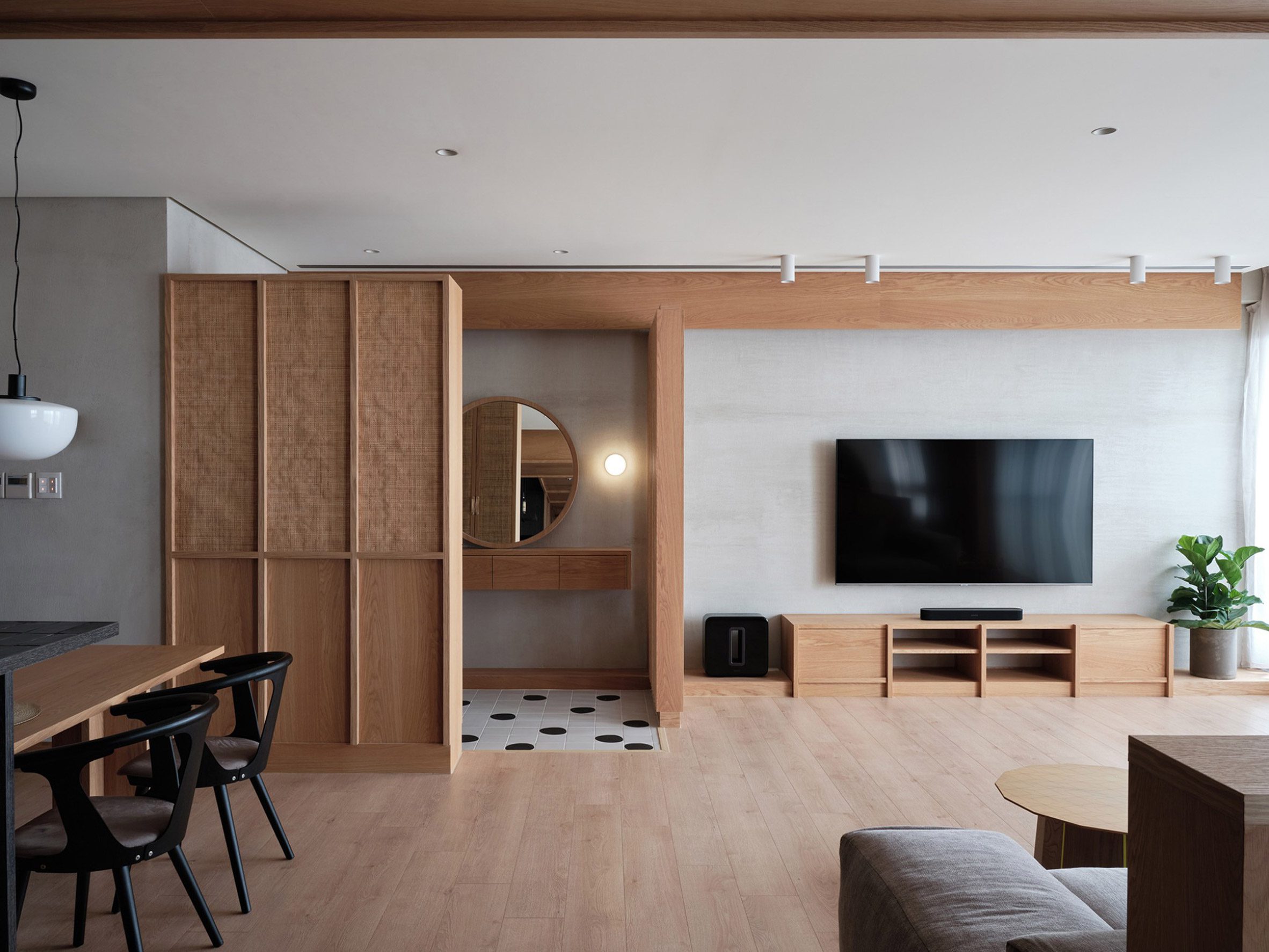 Living area and bathroom of Residence W divided by wooden screen