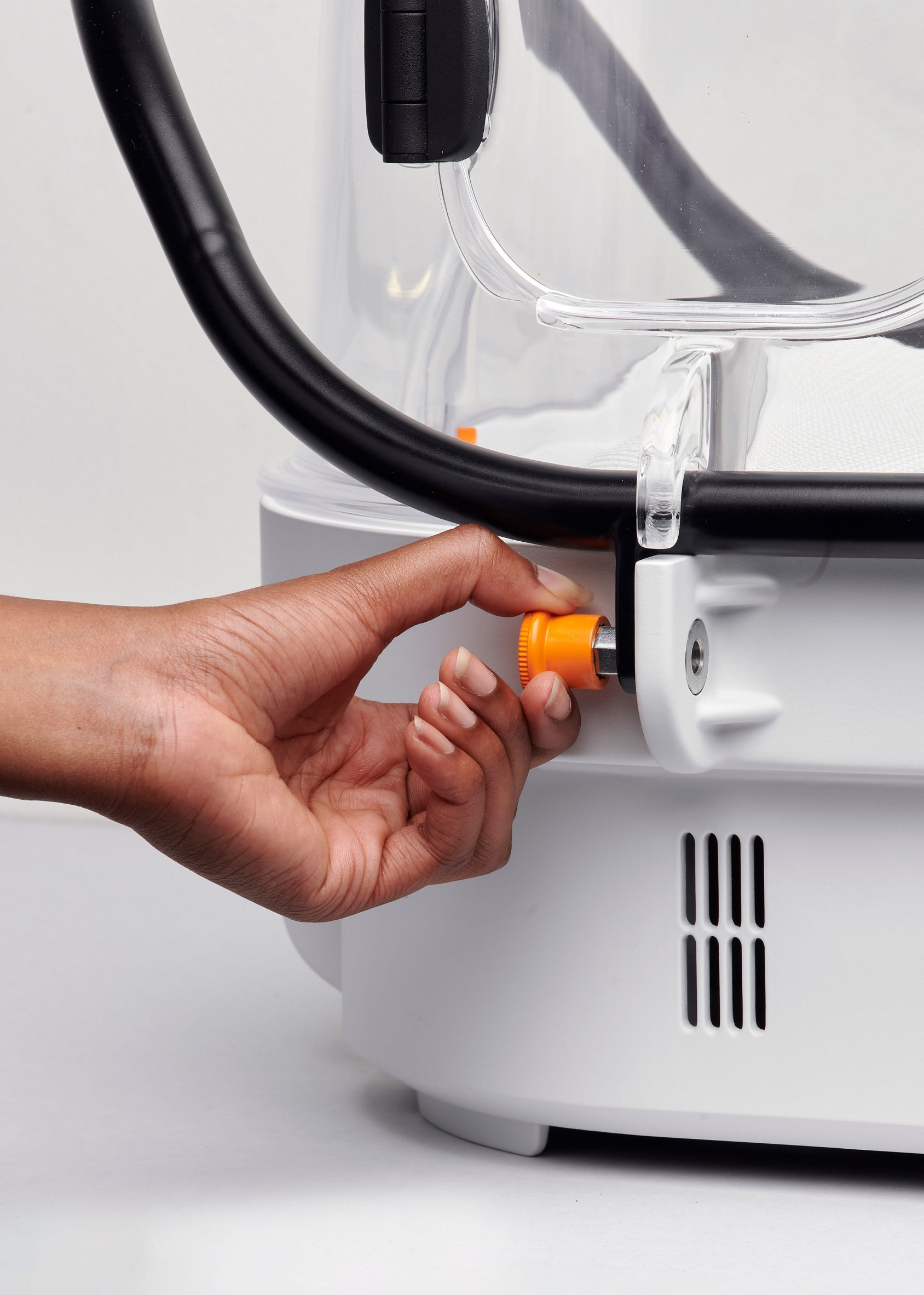 A hand unscrews an orange screw on Robust Nest