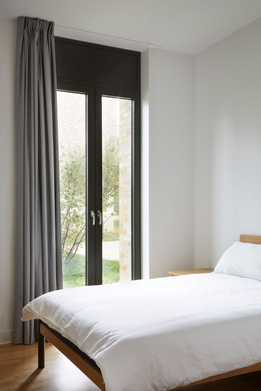 French doors in a bedroom lead out to a landscaped area