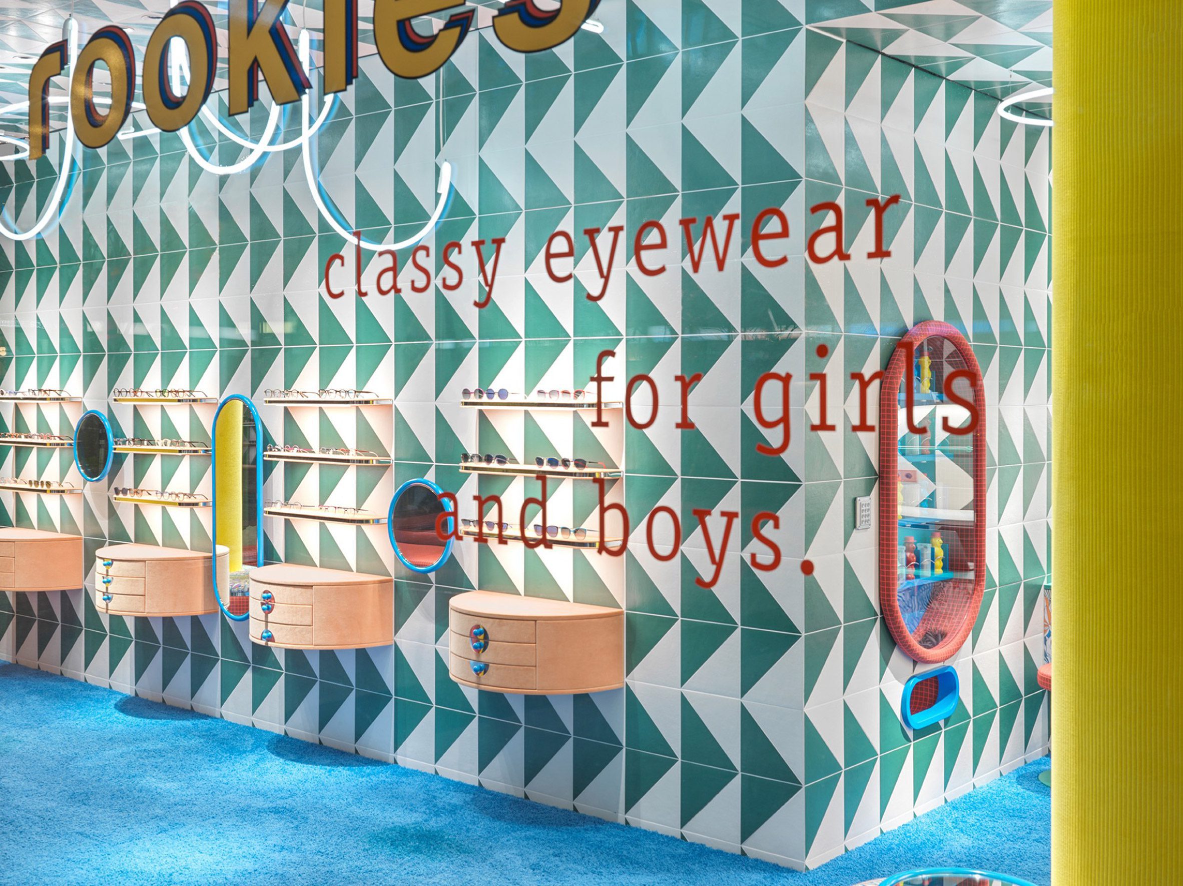 Brightly coloured tiles and carpet cover the walls and floor of the Leidmann eyewear store
