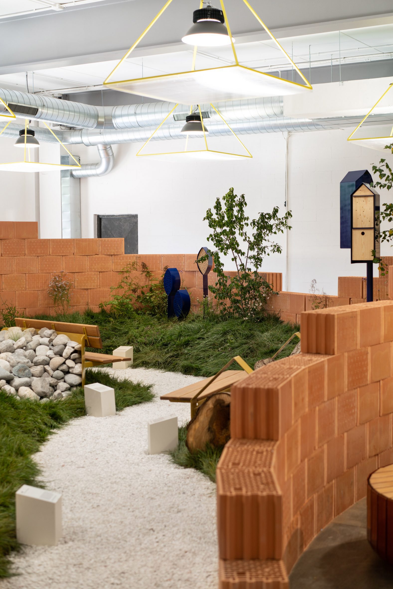 Indoor park installation by Note Design Studio with brick walls and stone floor