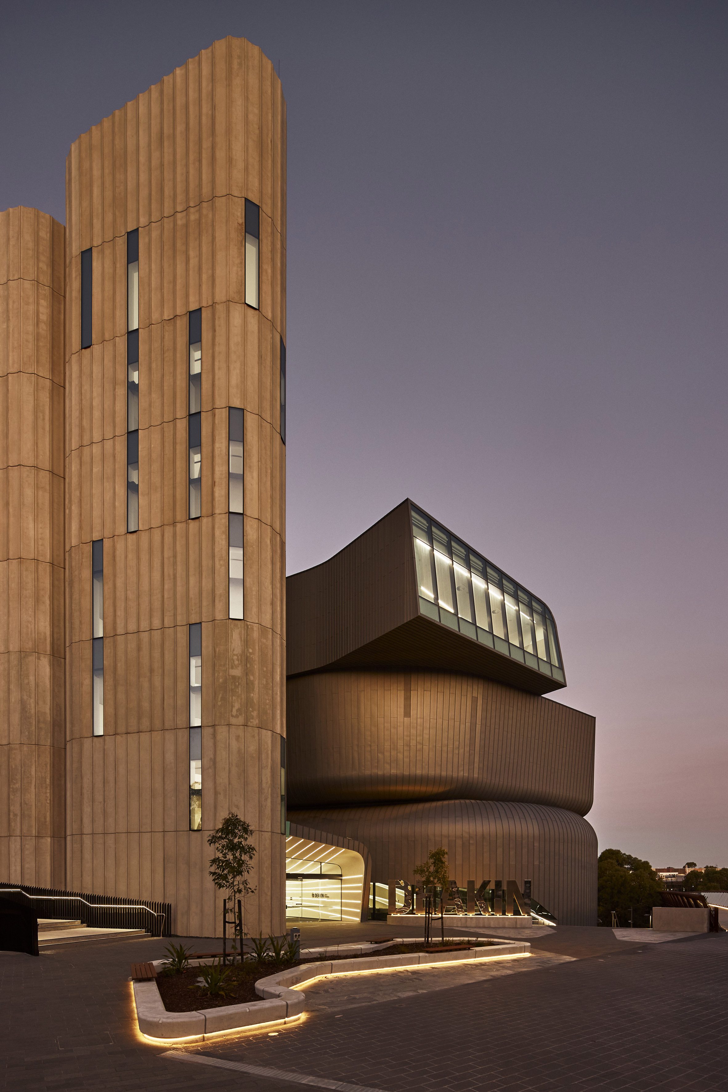 The Deakin Law School pictured at dusk with light reflecting off the exterior