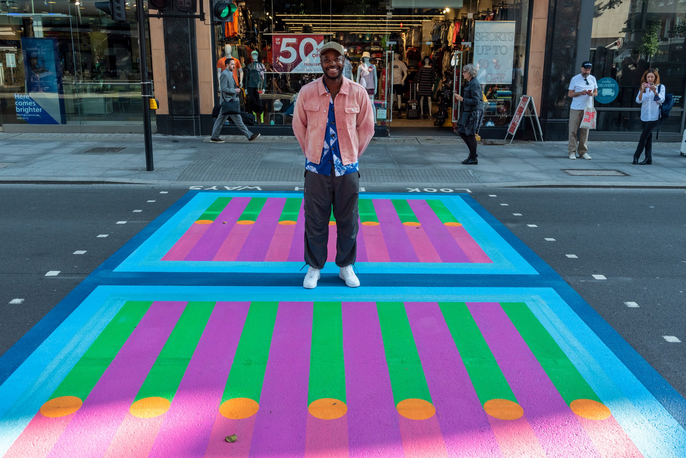 Yinka Ilori poses on his crossing for Bring London Together