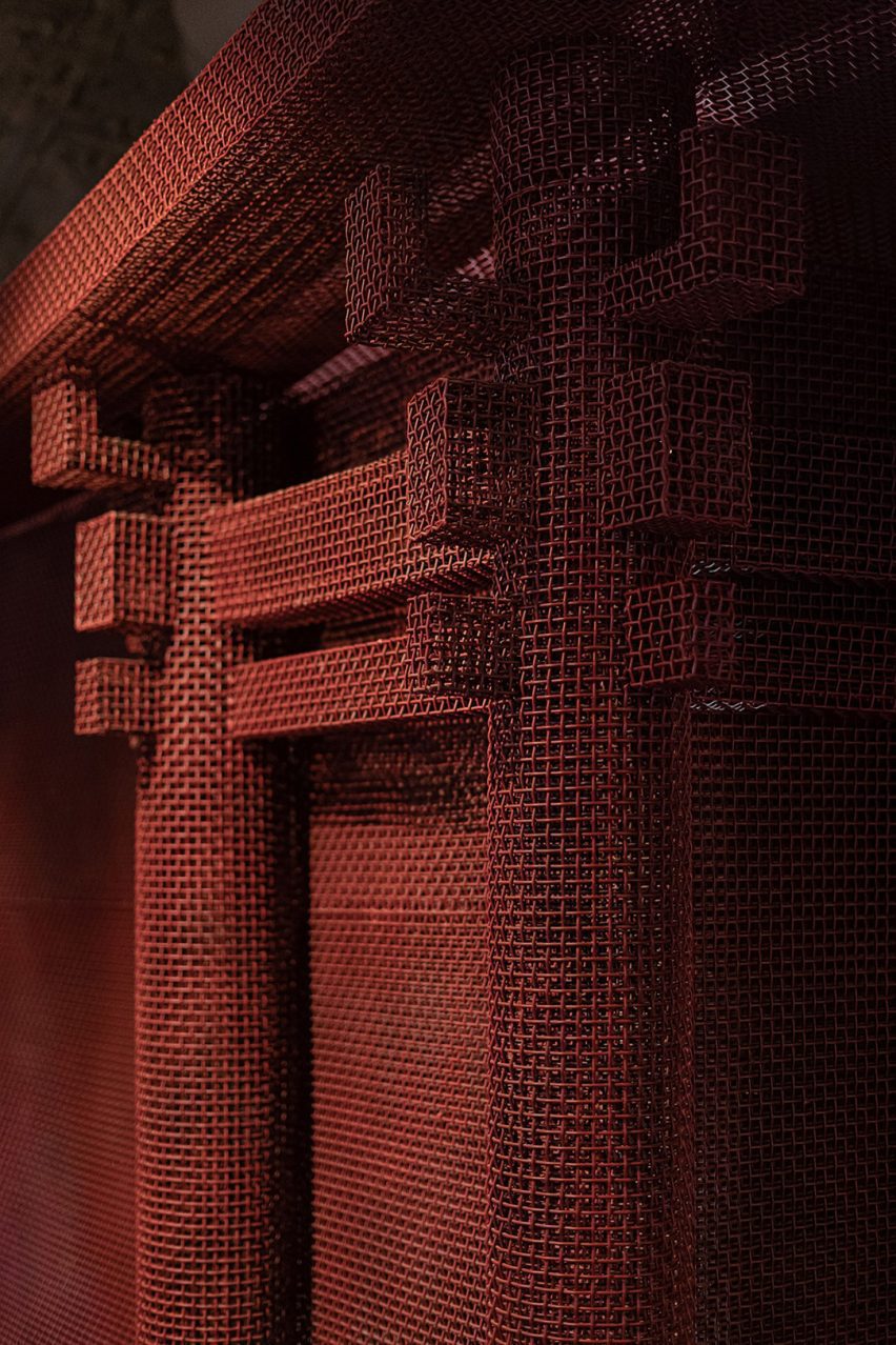Red metal mesh was shaped into architectural forms