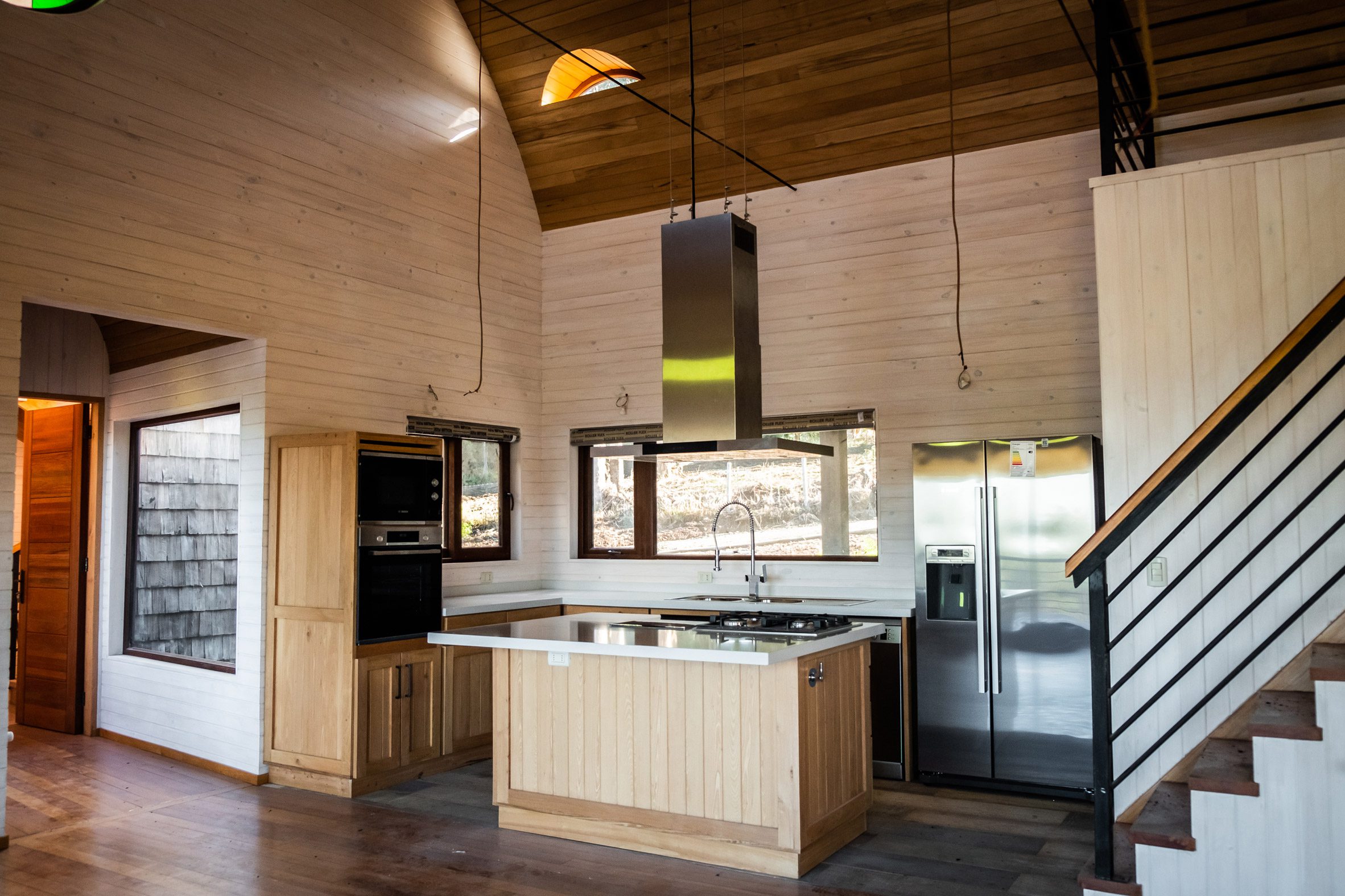 Wooden kitchen in the vaulted house