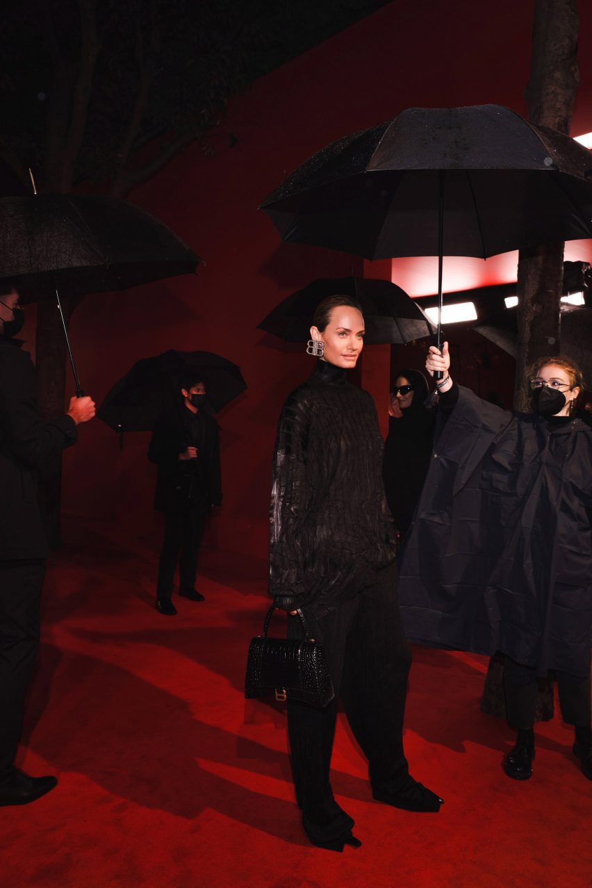 A model is covered with umbrellas at the balenciaga simspons premiere