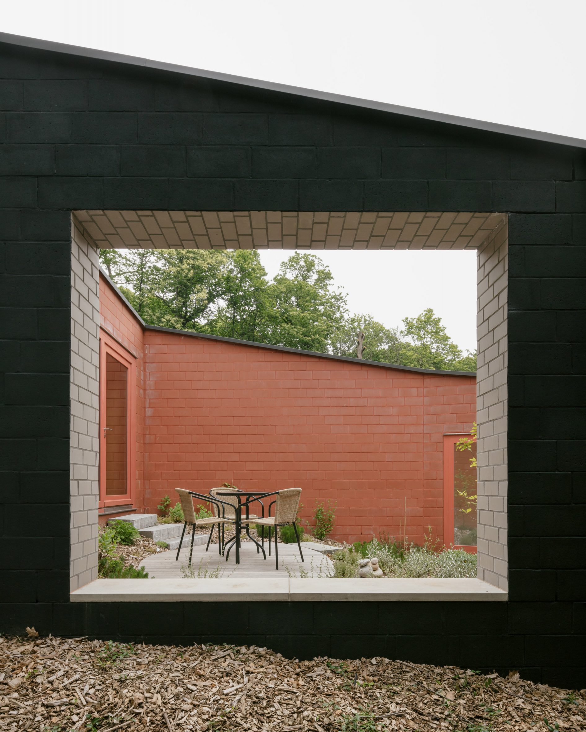 Window in black brick house