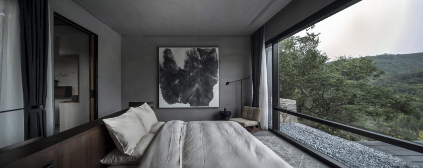 Bedroom with modern art in hotel by Gad Line+ Studio facing out at Mount Tai