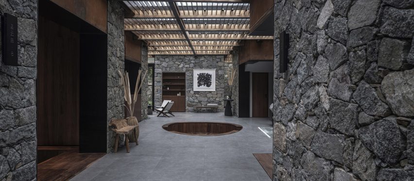 Sunken seating pit in Cloud of Hometown Resort Hotel surrounded by rough stone walls