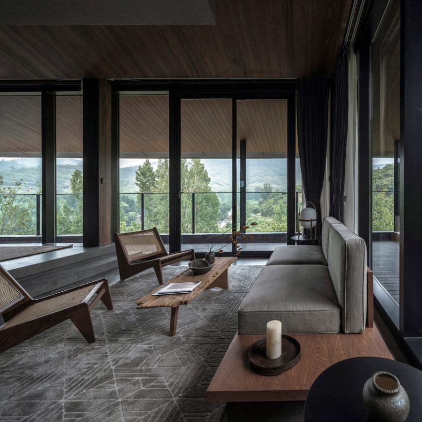 Seating area in front of panoramic windows in guest room of Cloud of Hometown Resort Hotel, China